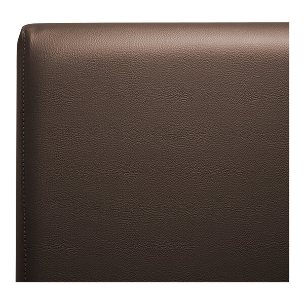 A close up of the brown leather back of a QA Group plain booth.