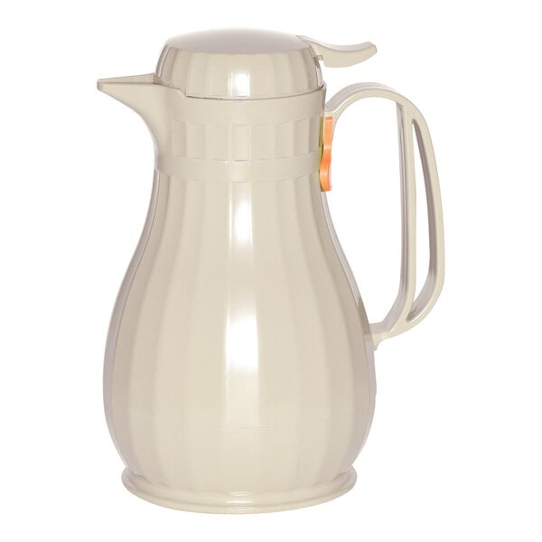 A white plastic coffee carafe with a handle.