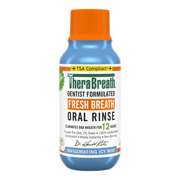 A TheraBreath blue bottle with white label and orange cap.