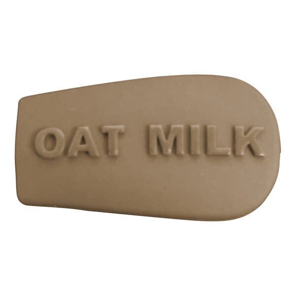 A brown soap bar with "oat milk" on a white letter K.