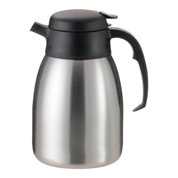 A silver stainless steel Service Ideas SteelVac coffee carafe with a black lid and handle.