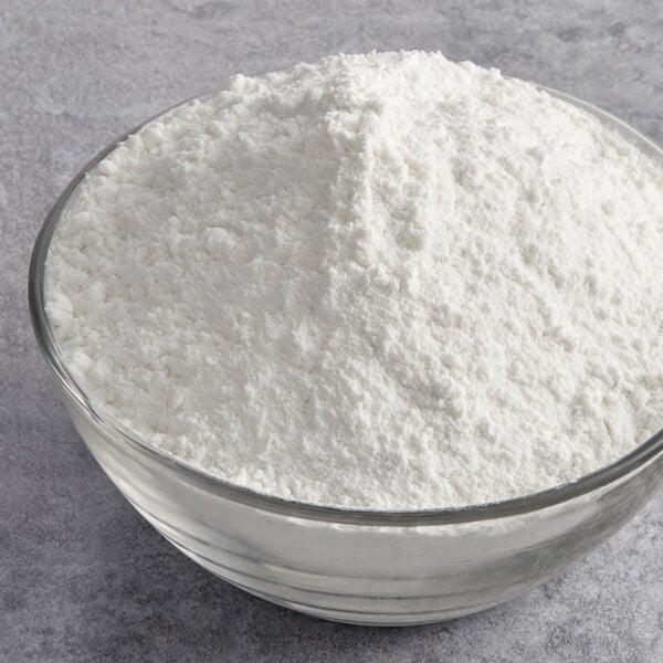 A glass bowl filled with white sweet rice flour.