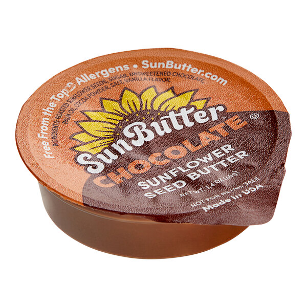 A close up of a SunButter Chocolate Sunflower Butter portion cup on a table.