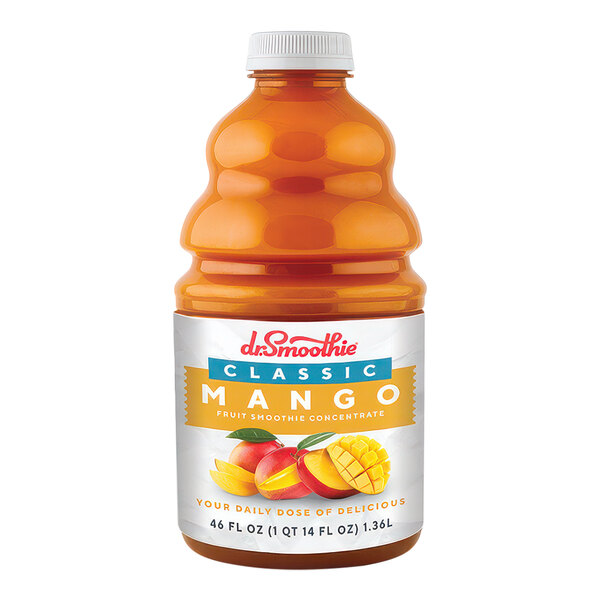 A close up of a bottle of Dr. Smoothie Classic Mango Fruit Smoothie Mix with a group of mangoes with leaves in the background.