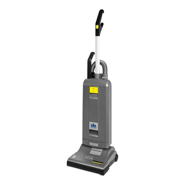 A grey rectangular Karcher Sensor S12 bagged vacuum cleaner with a yellow handle and black wheels.