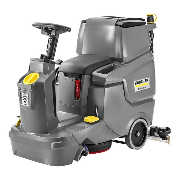 A Karcher ride-on floor scrubber with yellow wheels and a black seat.