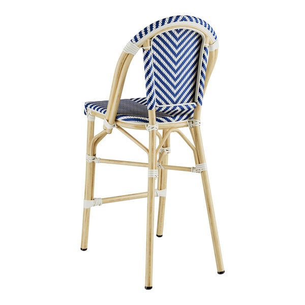 A blue and white striped Lancaster Table & Seating counter height outdoor barstool.