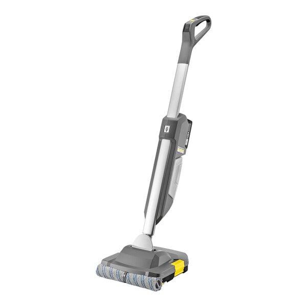 A Karcher walk-behind floor scrubber with a yellow and grey handle.