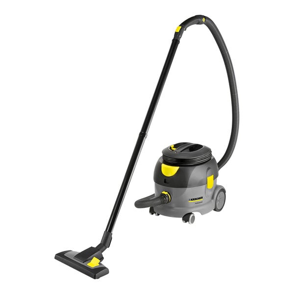 A Karcher dry canister vacuum cleaner with a yellow handle and black hose.