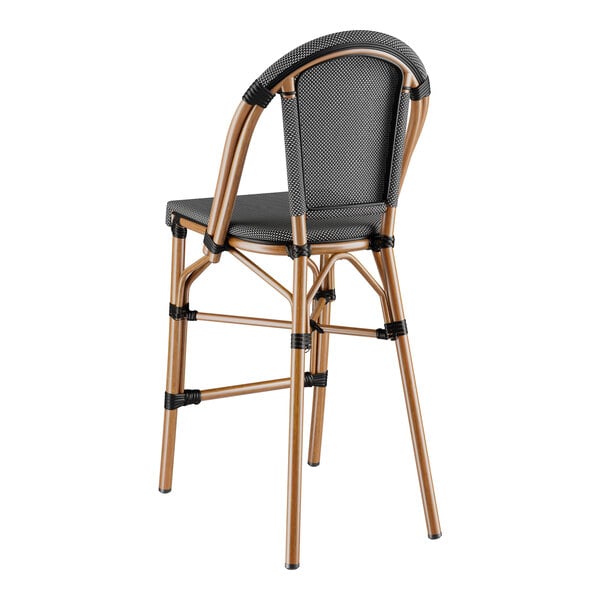 A Lancaster Table & Seating black and white barstool with a backrest and seat.