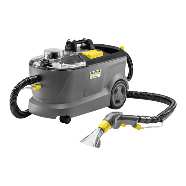 A Karcher Puzzi 10/1 C carpet spotter with a hose attached to it.