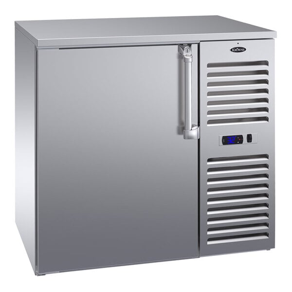 A Krowne stainless steel back bar refrigerator with a door open.