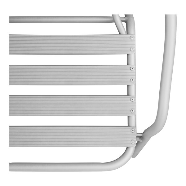 A close-up of a Lancaster Table & Seating silver powder-coated steel outdoor arm chair.