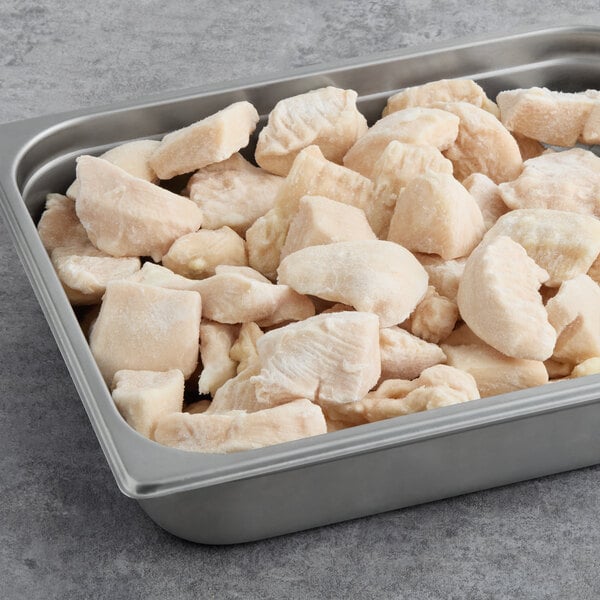 A tray of frozen Brakebush Farm Pantry boneless skinless halal chicken breast chunks.