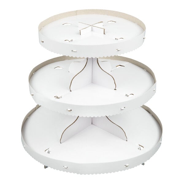 A three-tiered, round, white cardboard stand with scalloped edges, designed for displaying items such as cupcakes.