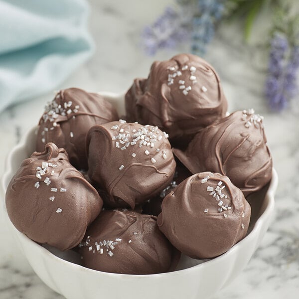 A white bowl of Guittard L'Etoile du Nord chocolate truffles.