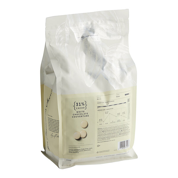 A white bag of Guittard Creme Francaise white chocolate wafers with a label.