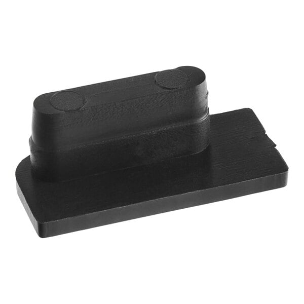 A black rectangular rubber foot with holes on one side.