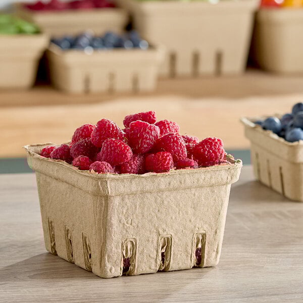 A Choice paper pulp basket of raspberries and blueberries.