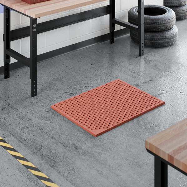 A heavy-duty red rubber anti-fatigue floor mat with a diamond pattern and straight edges, designed to be grease-resistant.