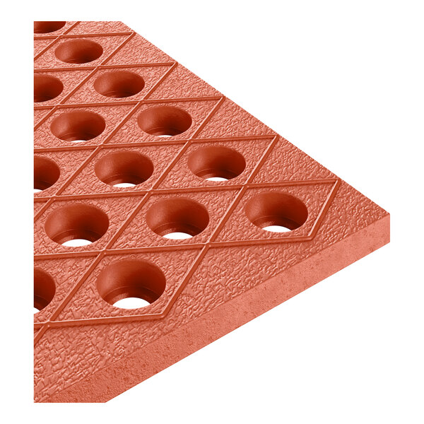 A heavy-duty red rubber anti-fatigue floor mat with diamond pattern and circular holes, designed for grease resistance.