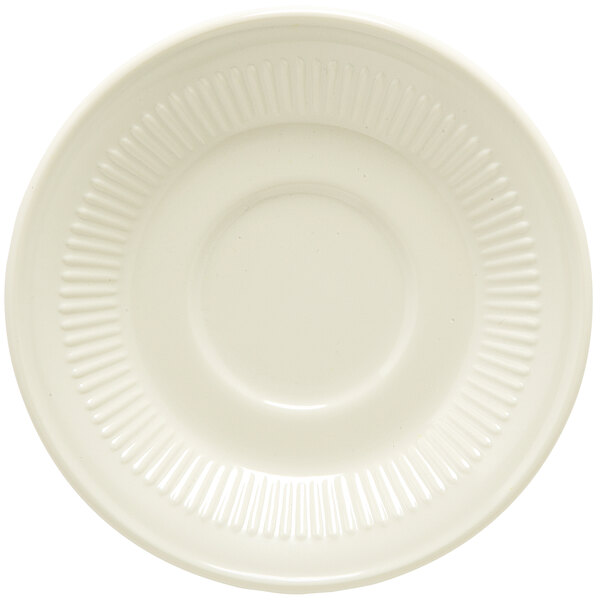 A close-up of a white saucer with a rippled rim.