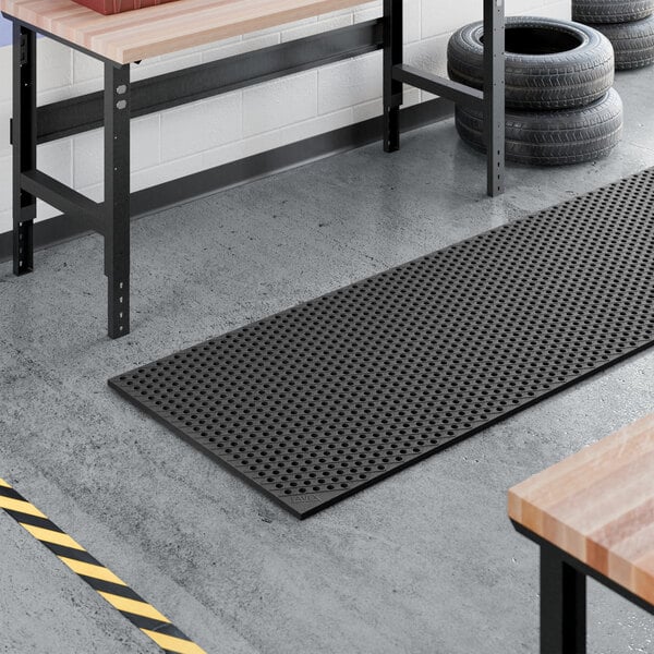 A heavy-duty black rubber anti-fatigue floor mat with a diamond pattern and straight edges, measuring 3 feet by 10 feet and 3/4 inch thick.