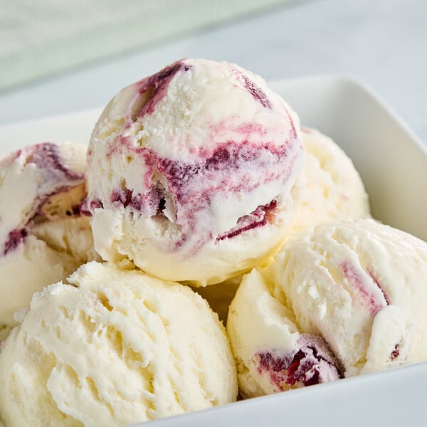 A scoop of Tillamook Marionberry Pie Premium Ice Cream in a bowl.