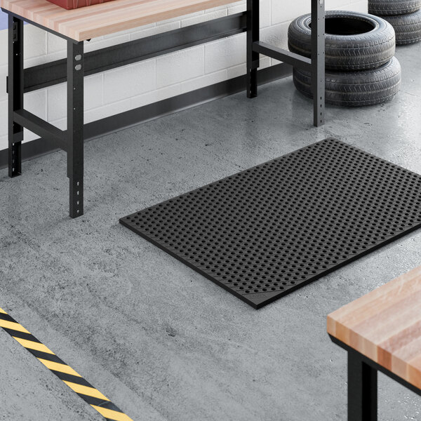 A heavy-duty black rubber anti-fatigue floor mat with a diamond pattern and straight edges, measuring approximately 3 1/4 feet by 4 15/16 feet and 7/8 inch thick.