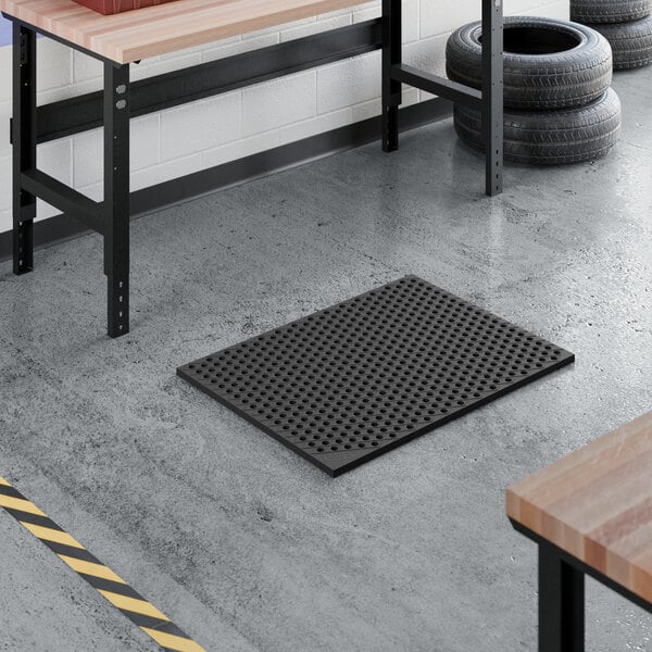 A heavy-duty black rubber anti-fatigue floor mat with a diamond pattern and straight edges, designed for industrial or workshop use.