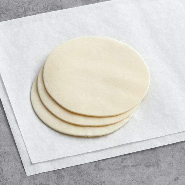 White Toque ready-to-bake empanada dough discs stacked on a white surface.