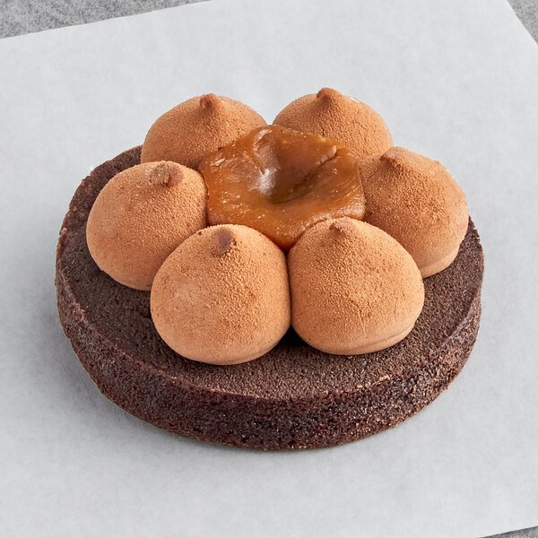 A White Toque chocolate tartlet with caramel and nuts on top.