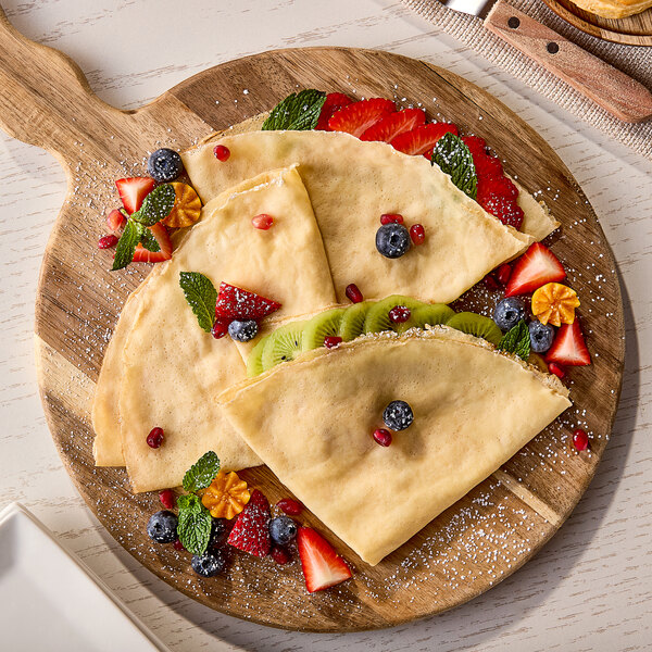A White Toque crepe with berries on a wooden board.