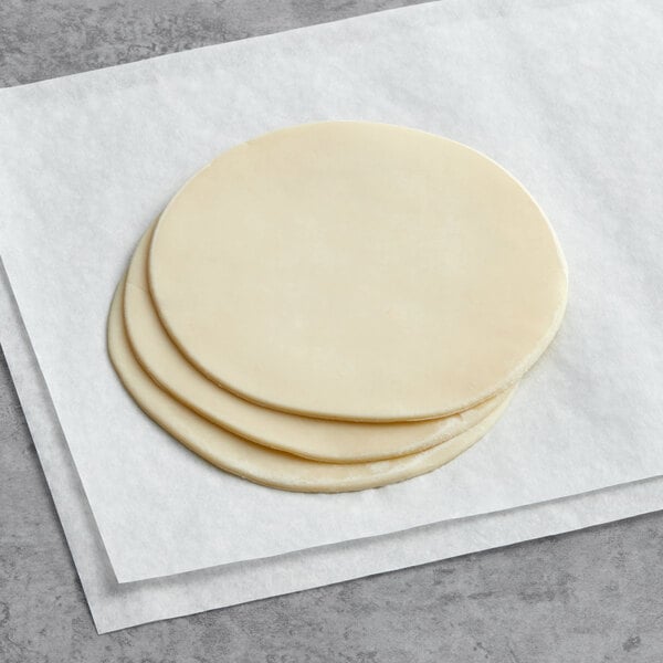 A stack of White Toque ready-to-fry empanada dough discs.