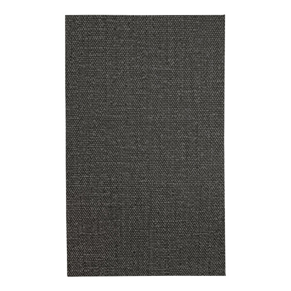 A close-up of a black fabric menu cover with a textured pattern.