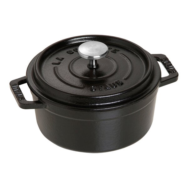 A black Staub enameled cast iron mini Dutch oven with a lid.