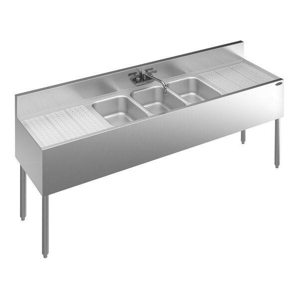 A Krowne stainless steel underbar sink with 3 bowls and 2 drainboards with a faucet.