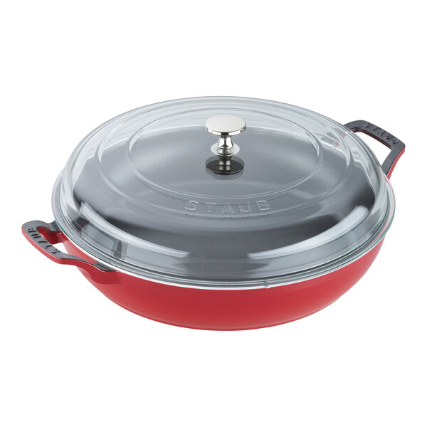 A red pot with a round base and a glass lid.