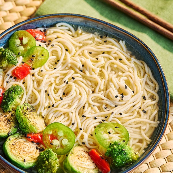 A bowl of Lotus Foods Organic Millet and Brown Rice Ramen with broccoli and peppers.