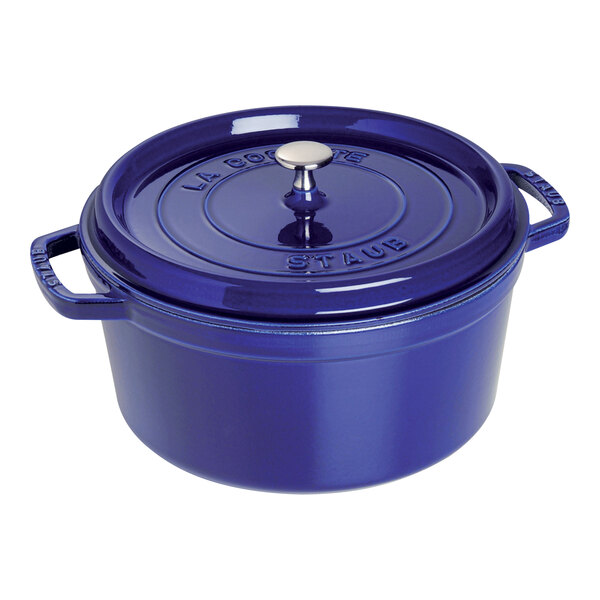 A dark blue Staub enameled cast iron pot with a lid.