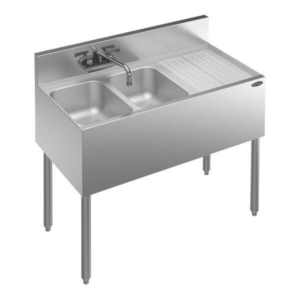 A stainless steel Krowne Royal Series underbar sink with faucet and right drainboard.