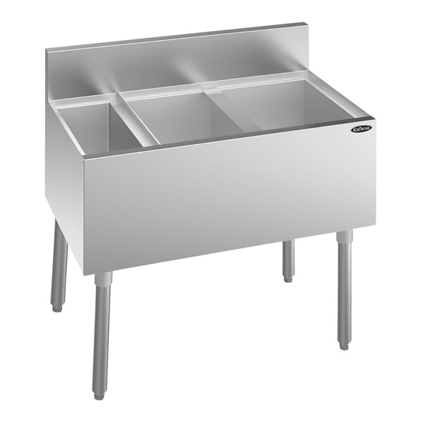 A silver stainless steel Krowne underbar ice bin with right-side bottle storage and three compartments.