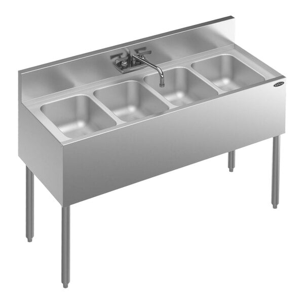 A Krowne stainless steel underbar sink with four compartments on a counter.