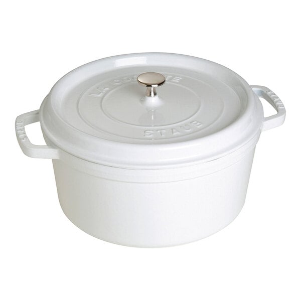 A white Staub enameled cast iron pot with a lid.