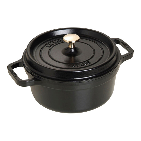 A black Staub enameled cast iron dutch oven with a lid.