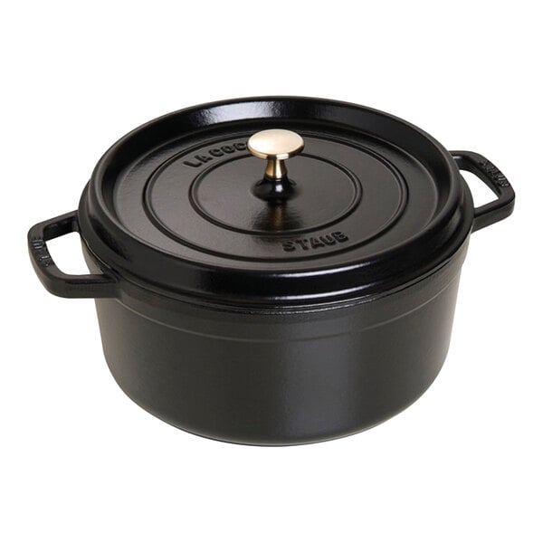 A black Staub enameled cast iron Dutch oven with a lid.