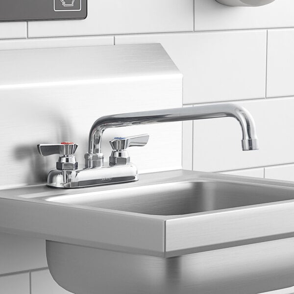 A Krowne deck-mount faucet with lever handles and a swing nozzle above a stainless steel sink.