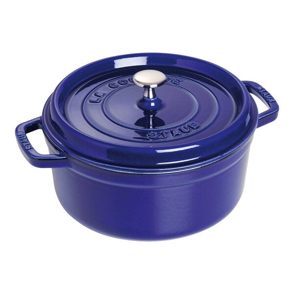 A dark blue Staub enameled cast iron pot with a lid and handle.