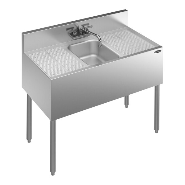 A Krowne stainless steel underbar sink with a faucet and 2 drainboards.