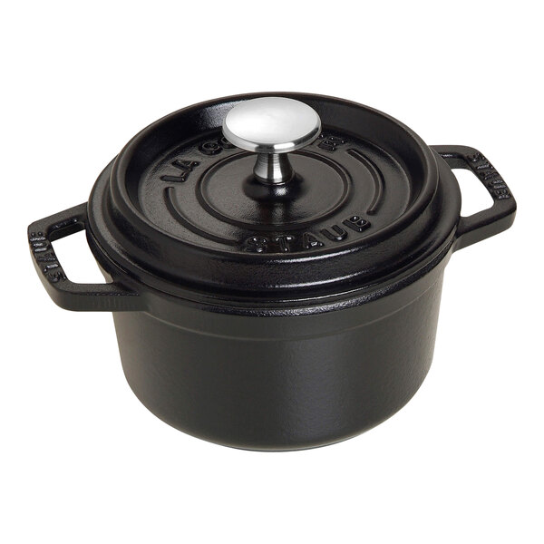 A black Staub enameled cast iron mini Dutch oven with a lid.